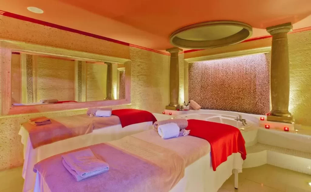 Habitación de spa en Mallorca con camillas, bañera empotrada y ambiente cálido para relajación y bienestar